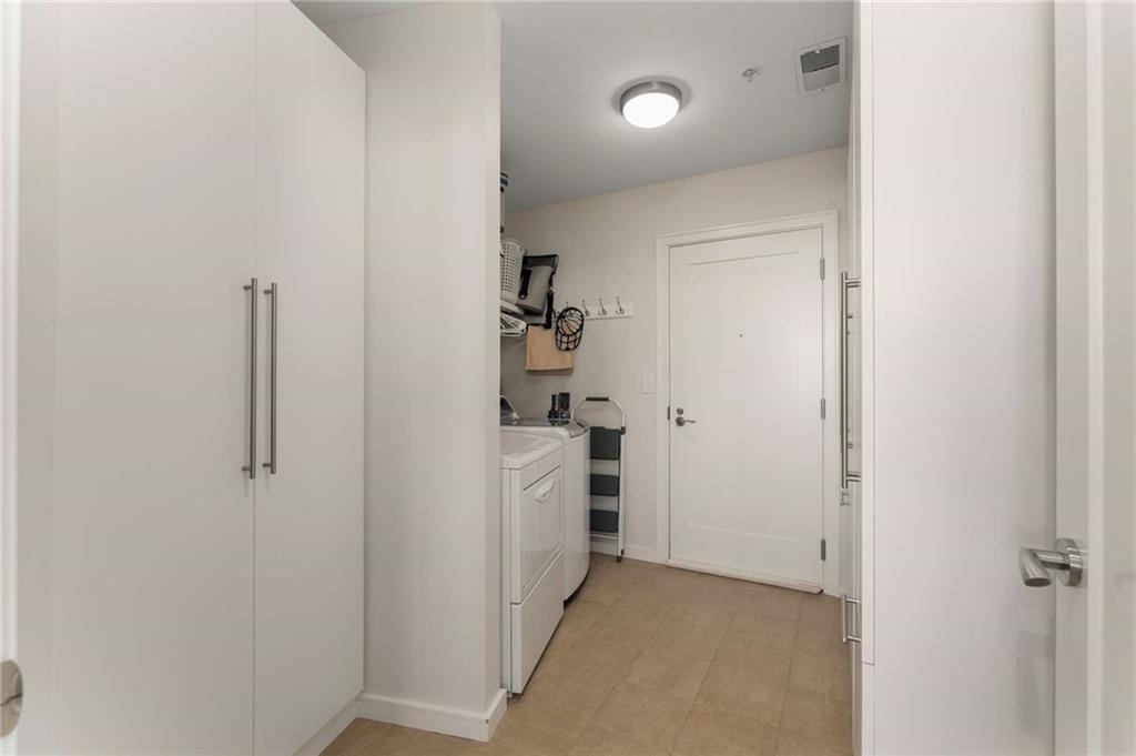 3325 Piedmont Road Northeast, Unit 2006 Atlanta, GA 30305 - Photo 21 of 78 a view of a hallway with closet and a fireplace
