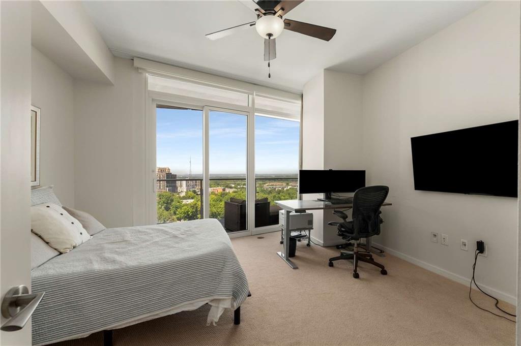 3325 Piedmont Road Northeast, Unit 2006 Atlanta, GA 30305 - Photo 24 of 78 a bedroom with a bed and a flat screen tv