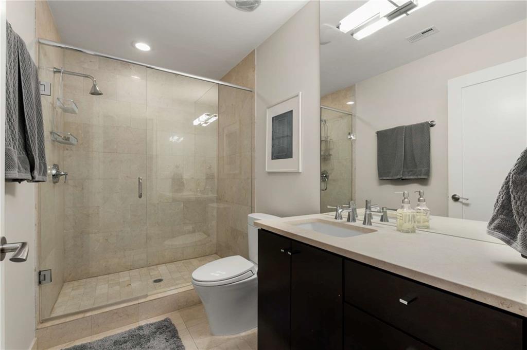 3325 Piedmont Road Northeast, Unit 2006 Atlanta, GA 30305 - Photo 27 of 78 a bathroom with a sink a toilet and shower