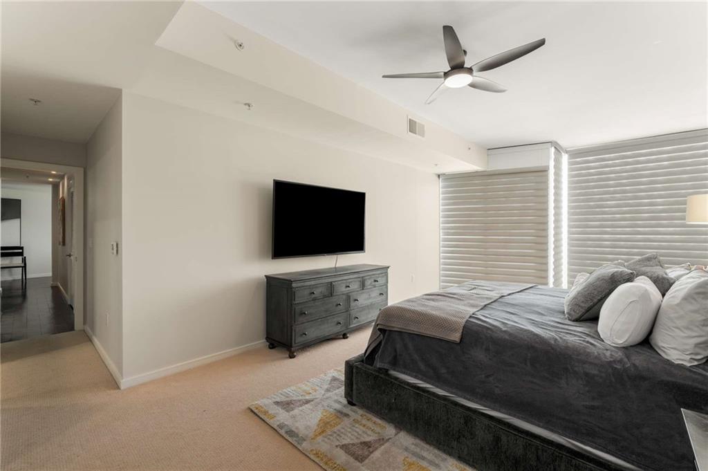 3325 Piedmont Road Northeast, Unit 2006 Atlanta, GA 30305 - Photo 30 of 78 a bedroom with a bed and a flat screen tv
