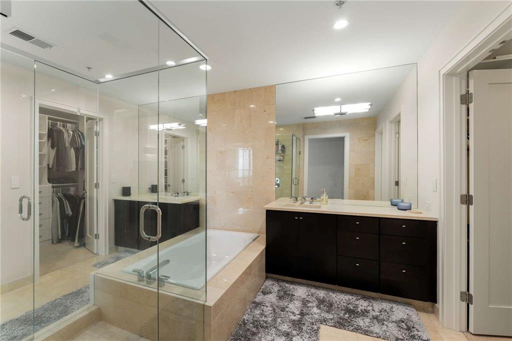 3325 Piedmont Road Northeast, Unit 2006 Atlanta, GA 30305 - Photo 35 of 78 a spacious bathroom with a tub sink shower and mirror