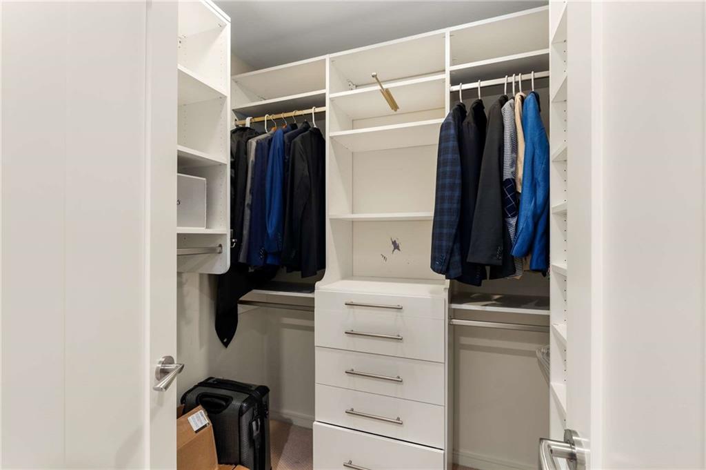 3325 Piedmont Road Northeast, Unit 2006 Atlanta, GA 30305 - Photo 36 of 78 a view of walk in closet with clothes and shoes