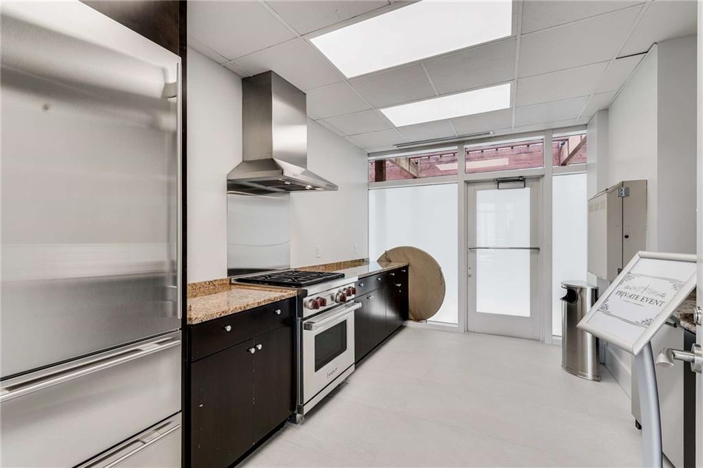 3325 Piedmont Road Northeast, Unit 2006 Atlanta, GA 30305 - Photo 53 of 78 a kitchen with stainless steel appliances granite countertop a refrigerator a stove and a sink with wooden floor