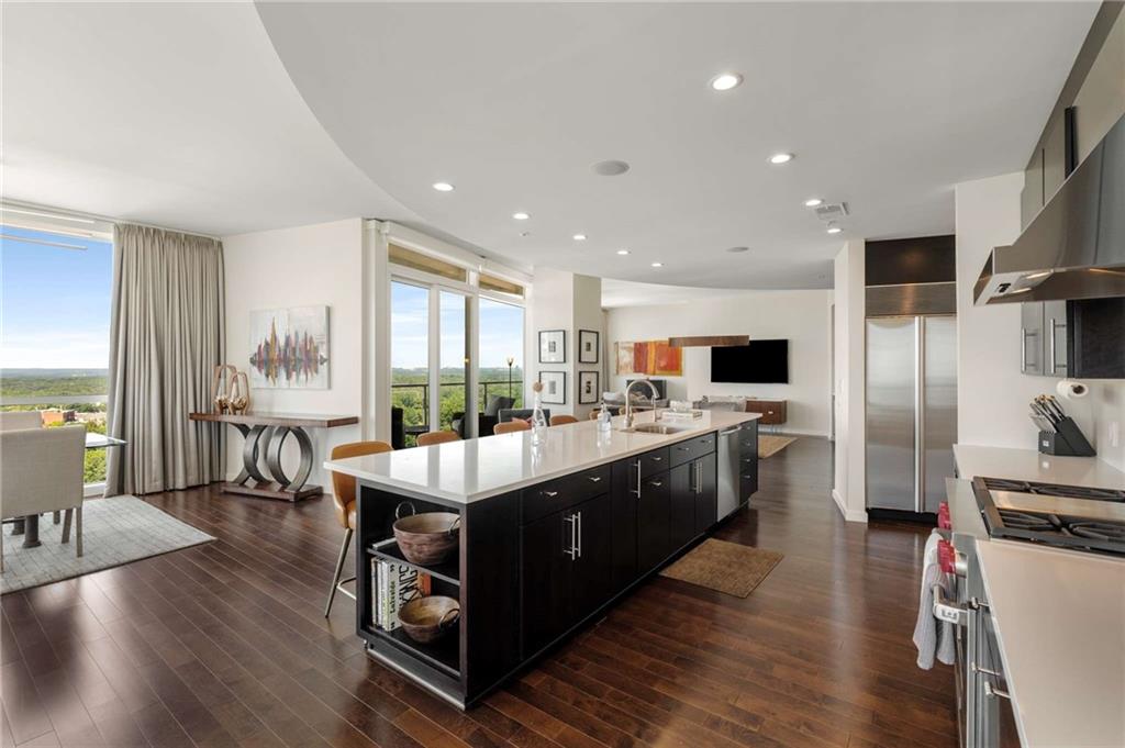 3325 Piedmont Road Northeast, Unit 2006 Atlanta, GA 30305 - Photo 10 of 78 a large kitchen with stainless steel appliances lots of counter space and windows