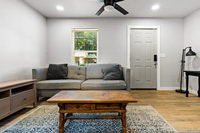 a living room with furniture and a rug