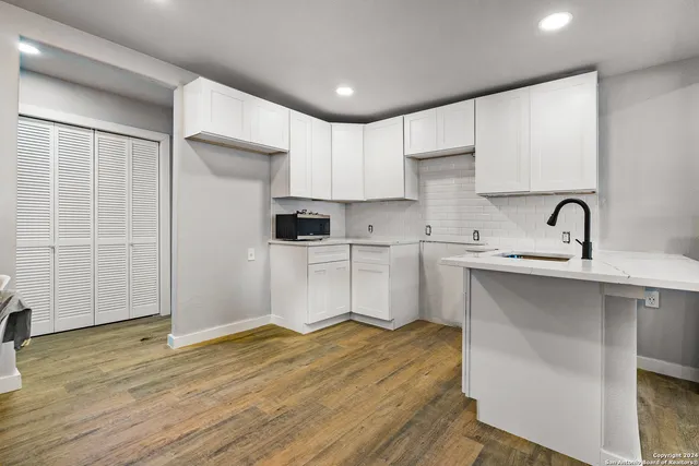 a kitchen with a sink stainless steel appliances and cabinets