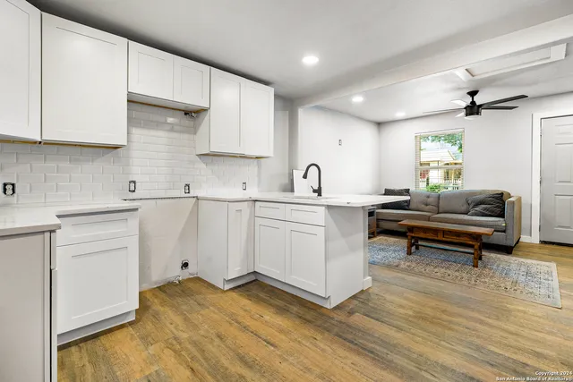 a kitchen with a sink stove and cabinets