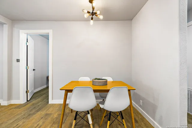 a workspace room with furniture and wooden floor