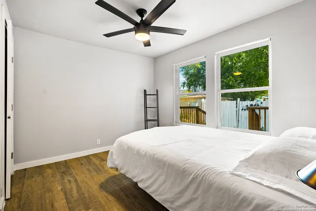 a bedroom with a large bed and a large window