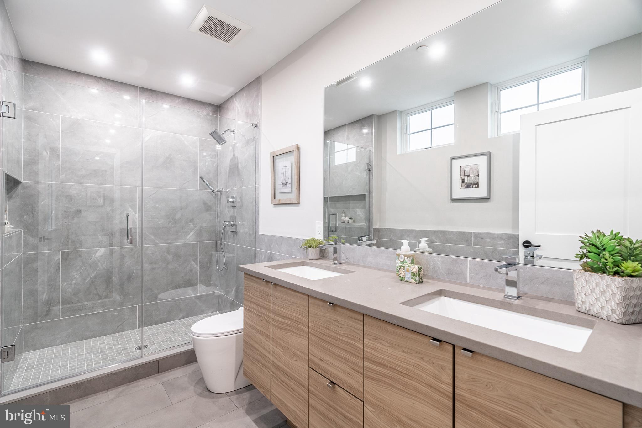 2412 Innovator Way Philadelphia, PA 19146 - Photo 11 of 117 a bathroom with a double vanity sink toilet and shower