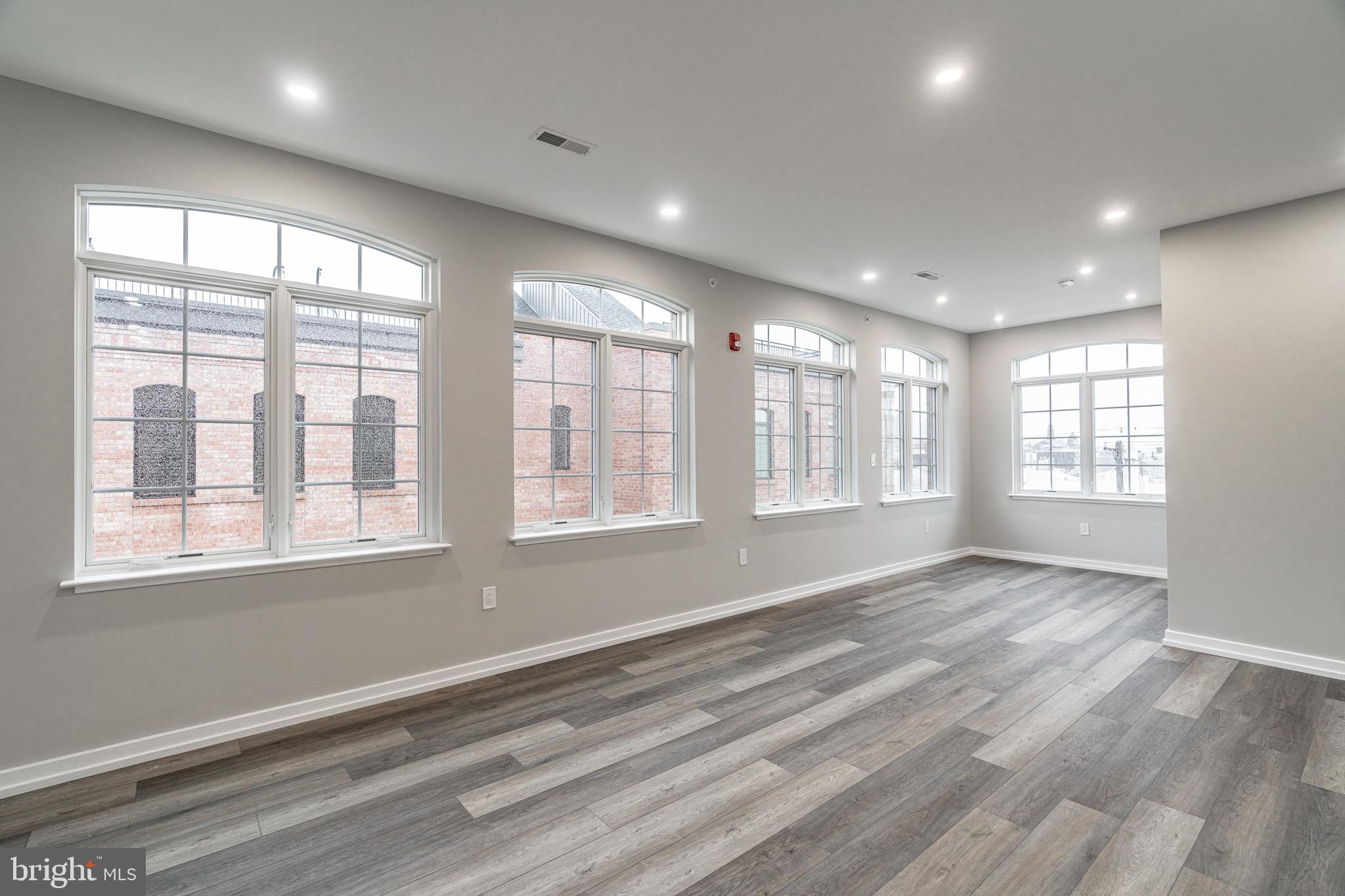 2412 Innovator Way Philadelphia, PA 19146 - Photo 111 of 117 a view of an empty room with a window and wooden floor