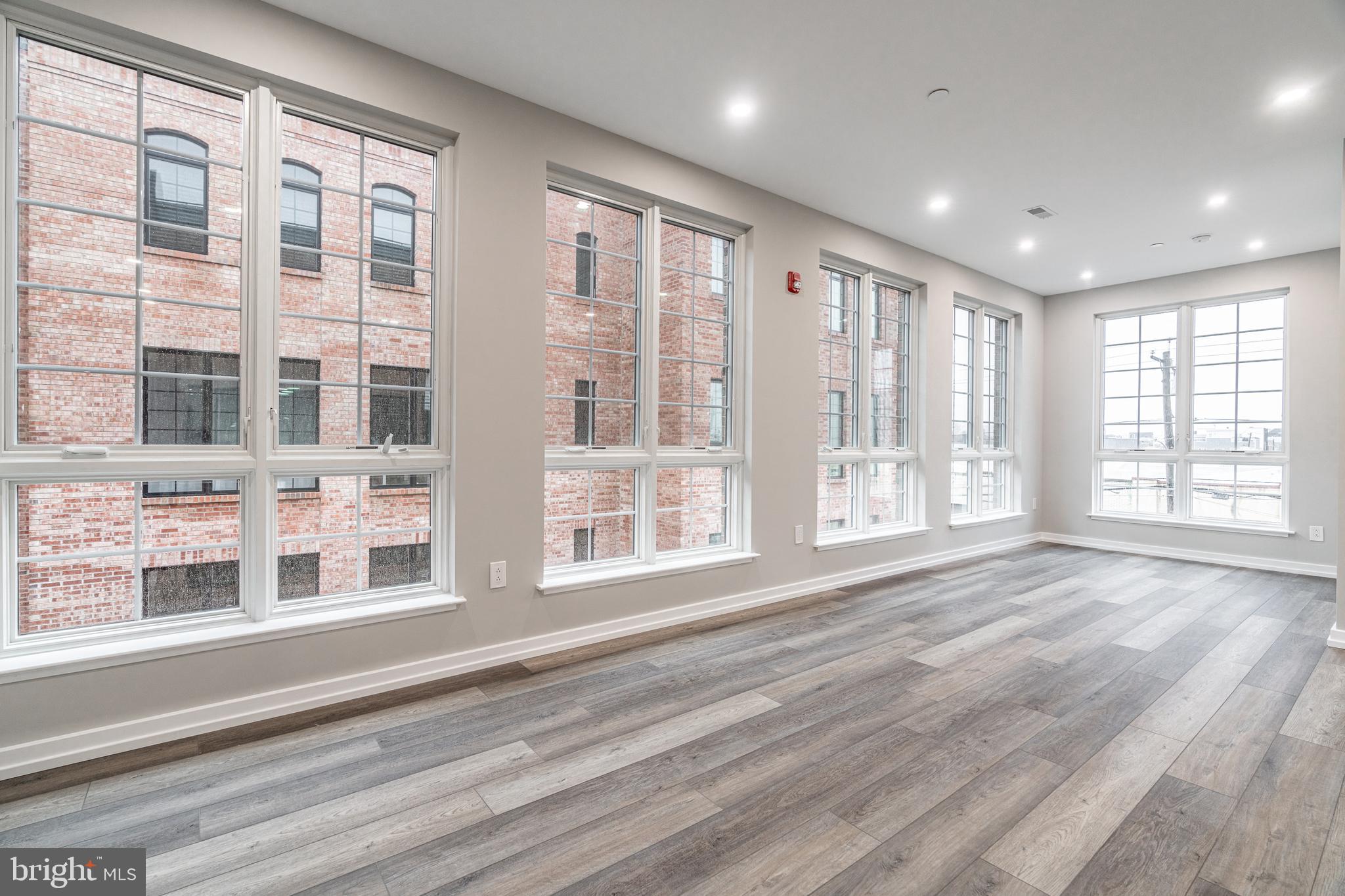 2412 Innovator Way Philadelphia, PA 19146 - Photo 13 of 117 a view of an empty room with a window and wooden floor