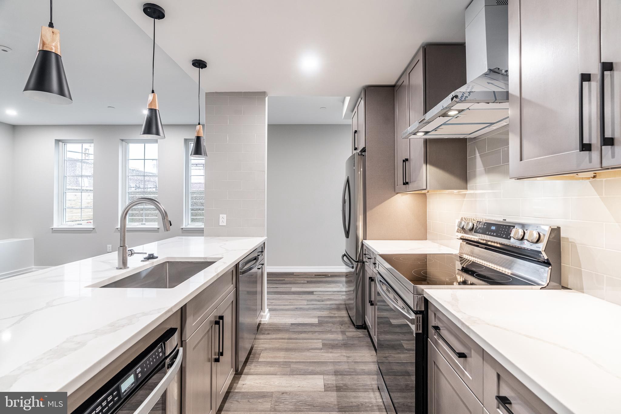 2412 Innovator Way Philadelphia, PA 19146 - Photo 21 of 117 a kitchen with stainless steel appliances a sink stove and refrigerator