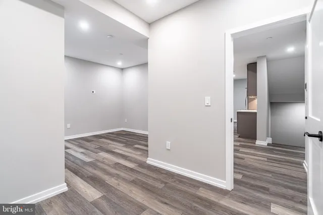 a view of a hallway with wooden floor