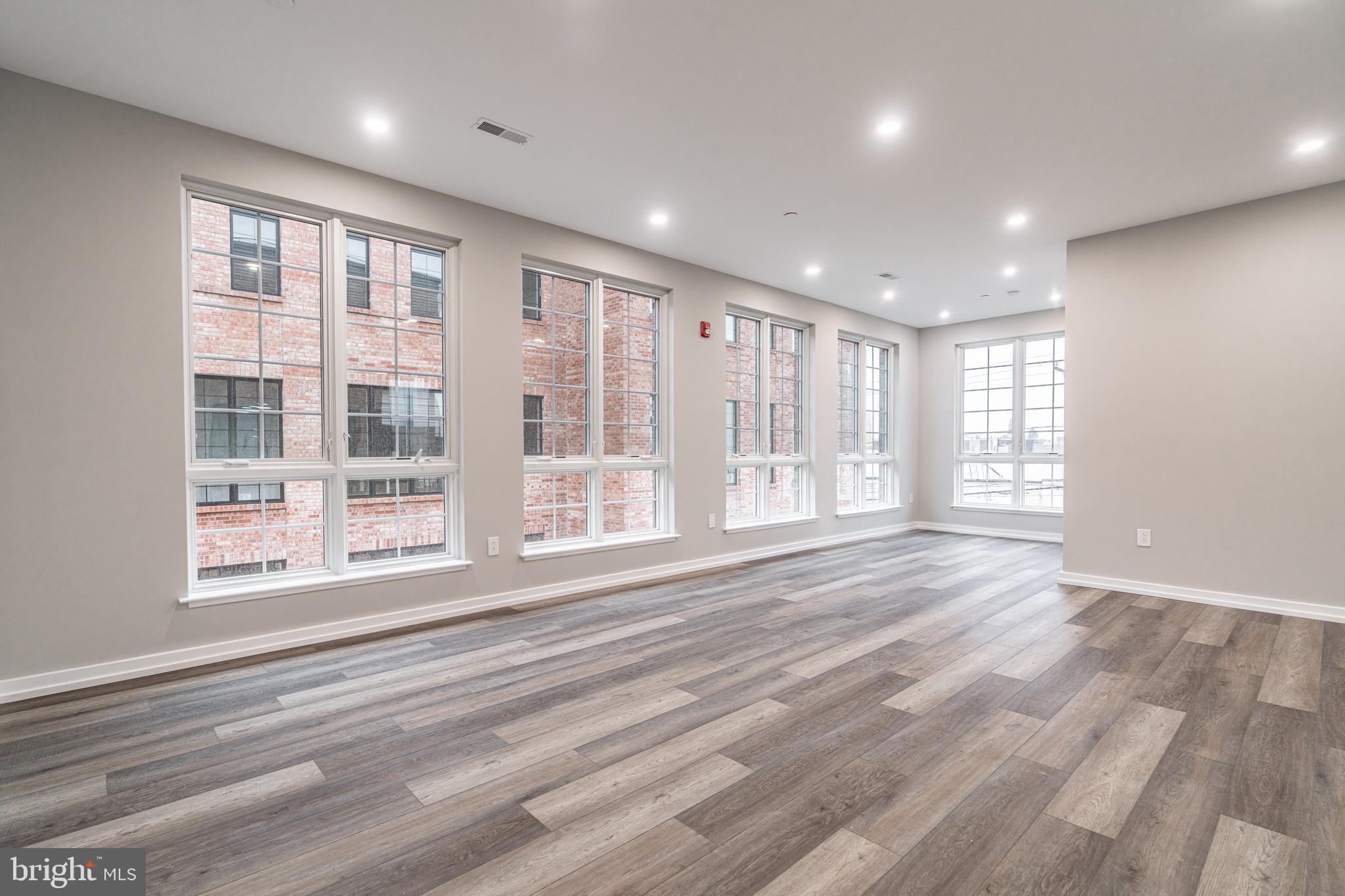 2412 Innovator Way Philadelphia, PA 19146 - Photo 78 of 117 a view of an empty room with a window and wooden floor