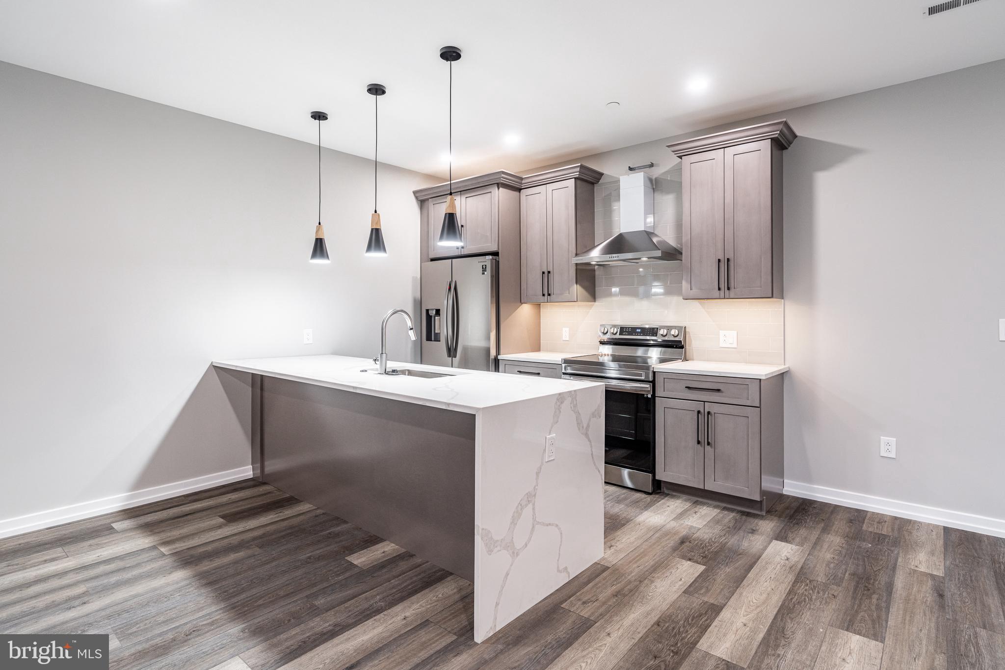 2412 Innovator Way Philadelphia, PA 19146 - Photo 85 of 117 a kitchen with kitchen island a sink stainless steel appliances and cabinets