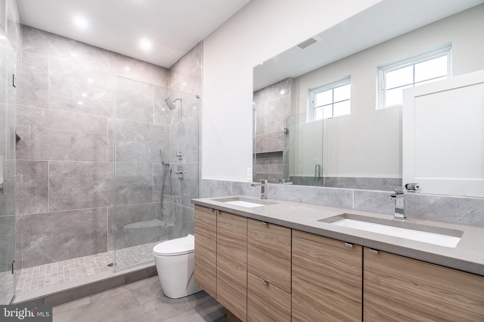 2412 Innovator Way Philadelphia, PA 19146 - Photo 99 of 117 a bathroom with a double vanity sink toilet mirror and shower