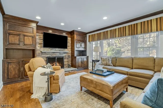 a living room with fireplace furniture and a flat screen tv