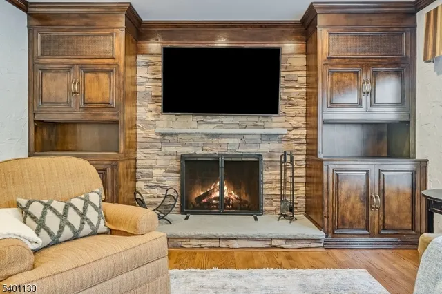 a living room with a fireplace and a flat screen tv