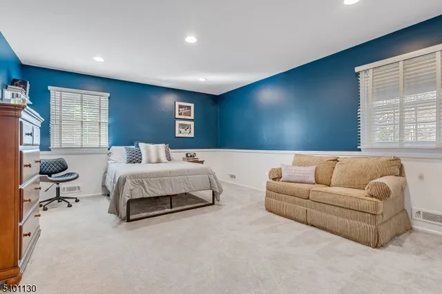 a bedroom with a bed and glass windows