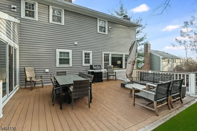 a backyard of a house with wooden floor outdoor seating and yard in the back