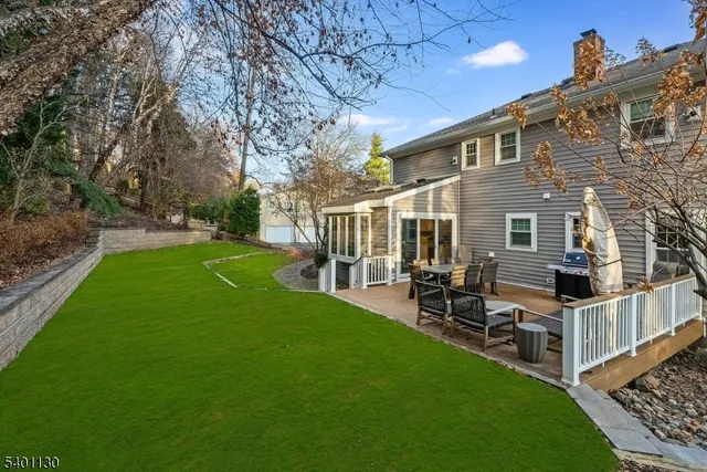 a view of a patio with table and chairs and wooden fence