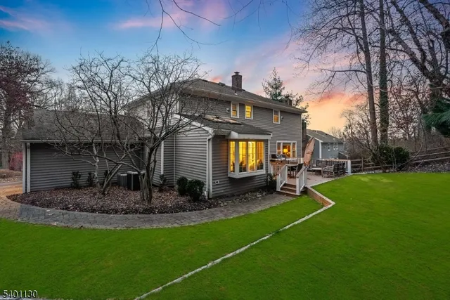a view of a chair and table in backyard of the house