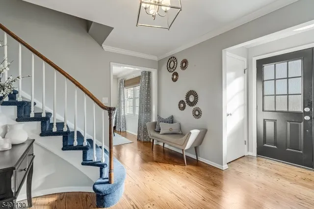 a view of an entryway with wooden floor and stairs