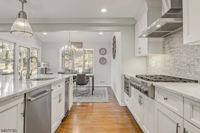 a kitchen with granite countertop a sink stove and cabinets