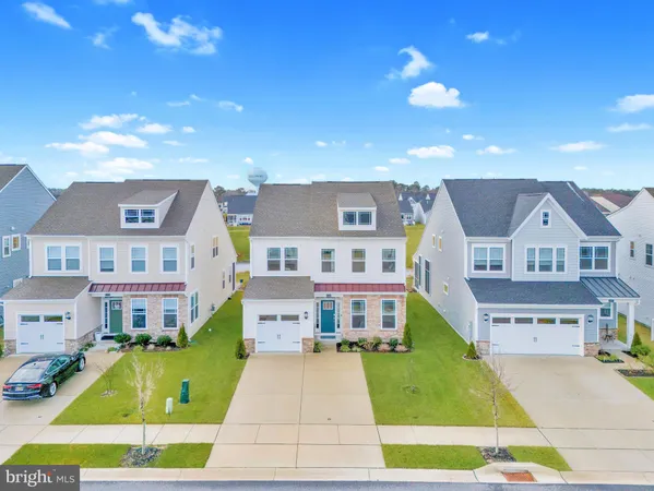 a aerial view of a house with a yard porch and furniture