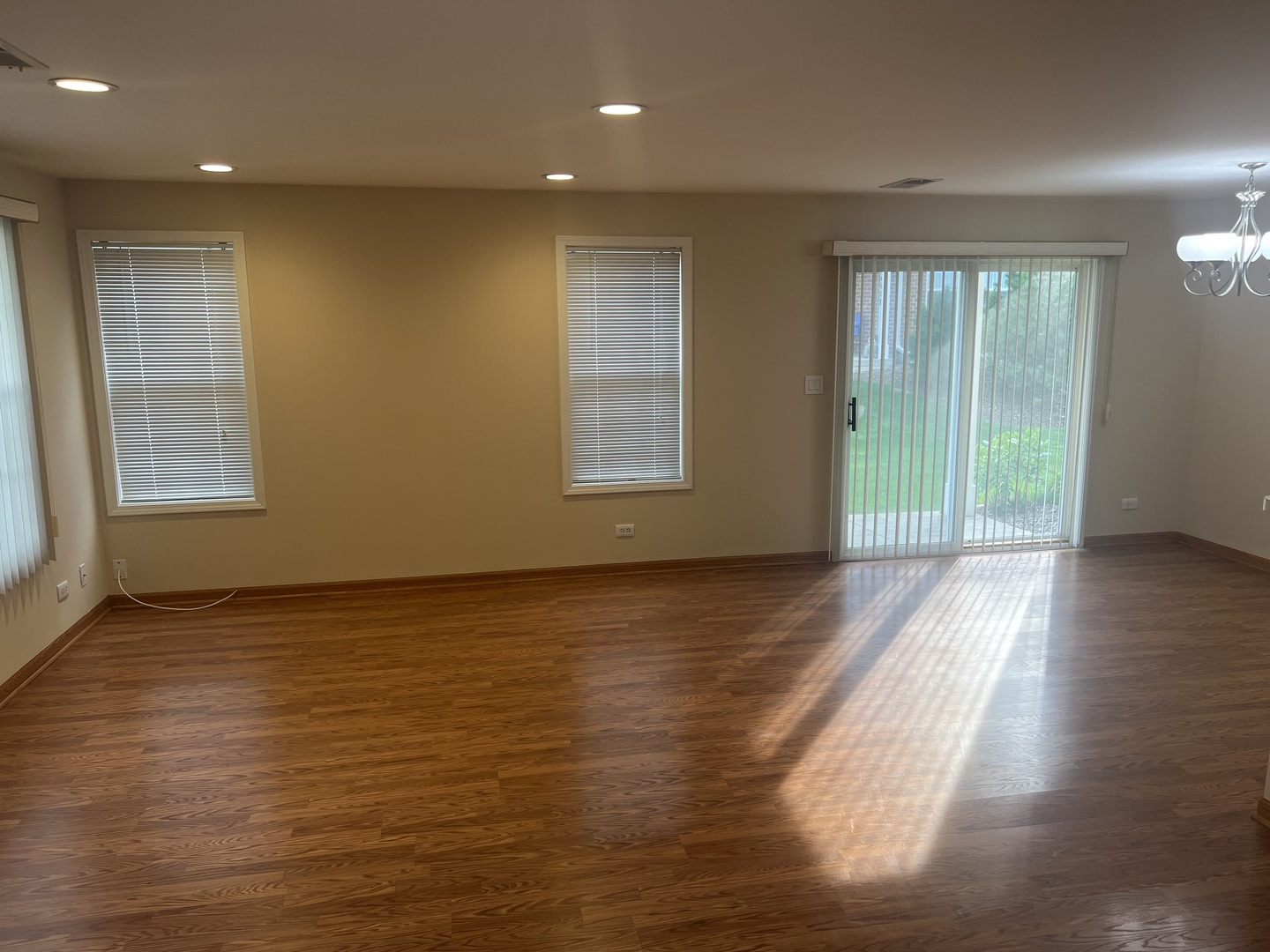 250 Regal Court Roselle, IL 60172 - Photo 4 of 17 a view of an empty room with wooden floor and a window
