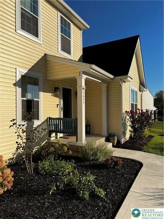 a front view of house with yard and green space