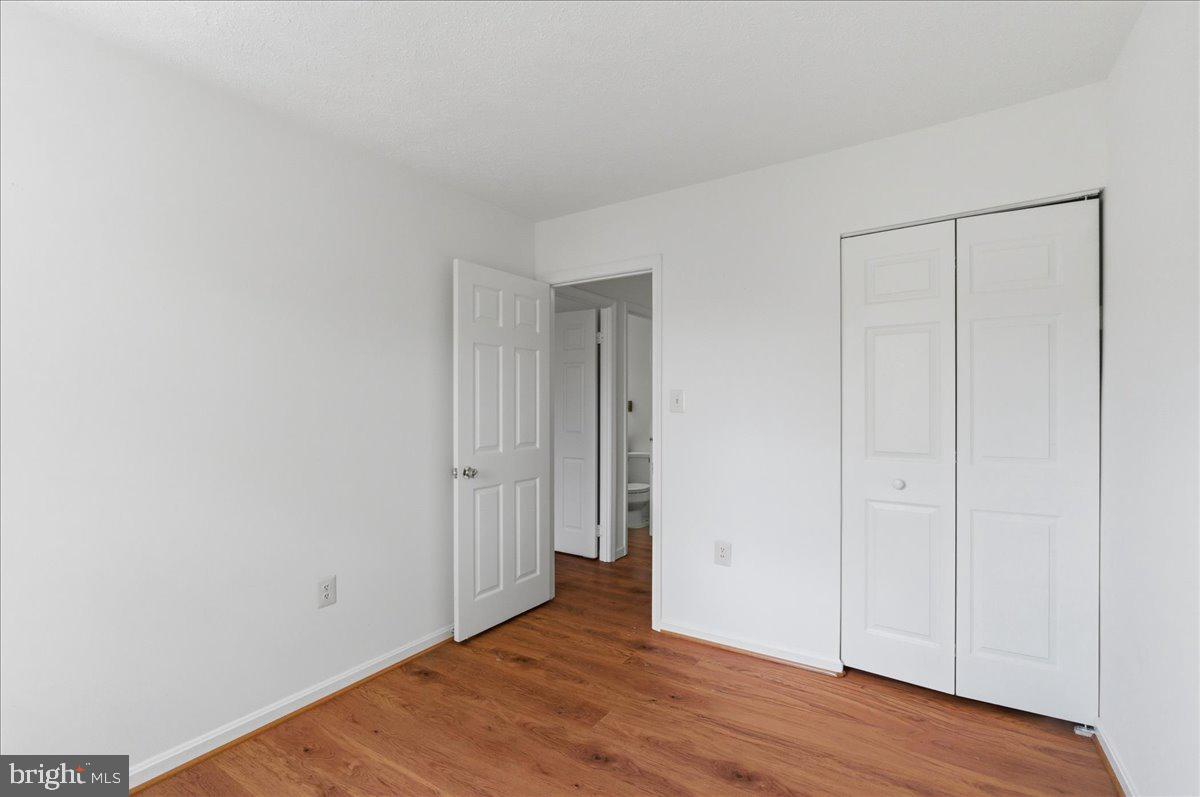 10177 Irongate Way Manassas, VA 20109 - Photo 15 of 28 a view of an empty room with wooden floor