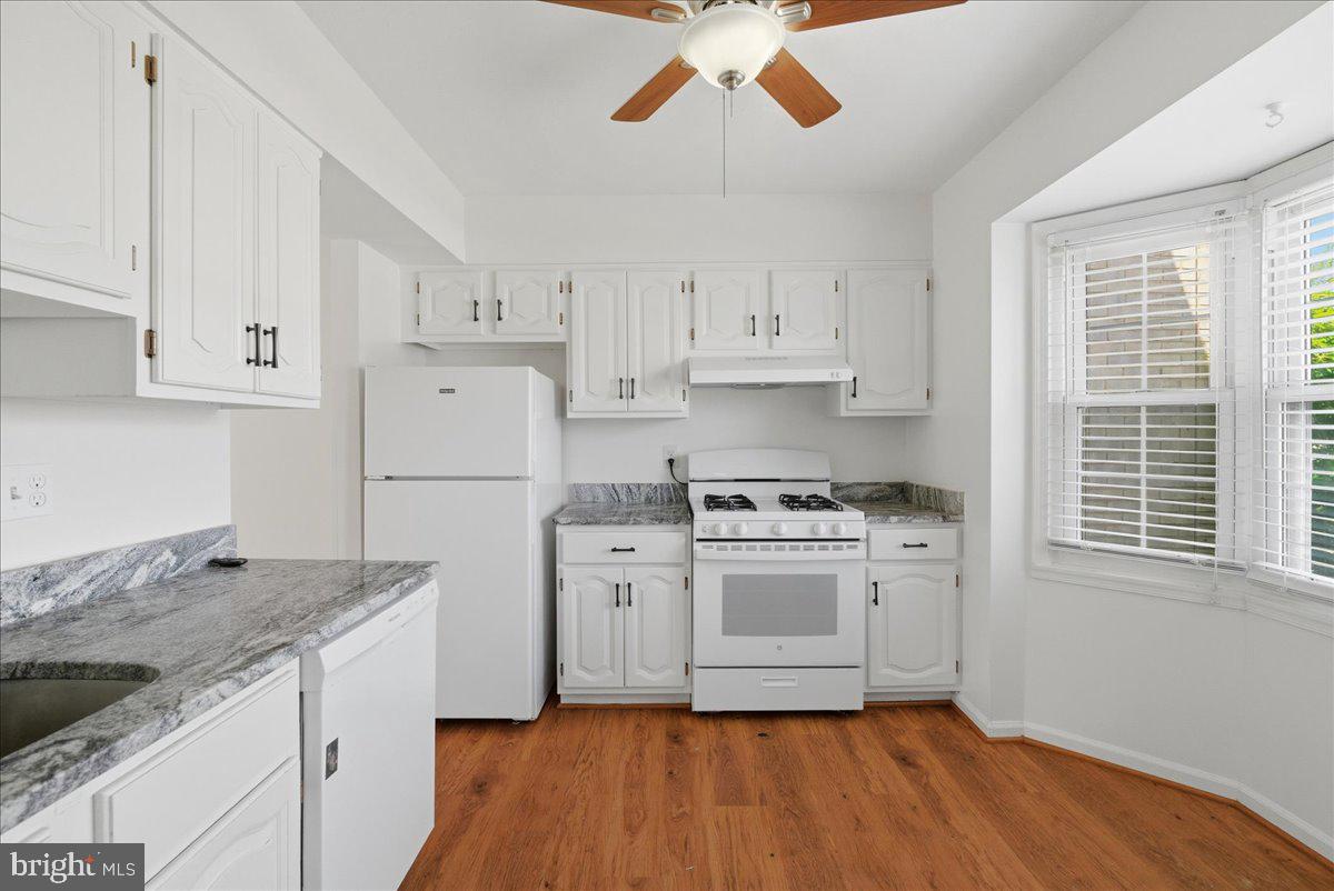 10177 Irongate Way Manassas, VA 20109 - Photo 19 of 28 a kitchen with stainless steel appliances granite countertop a stove a sink and white cabinets