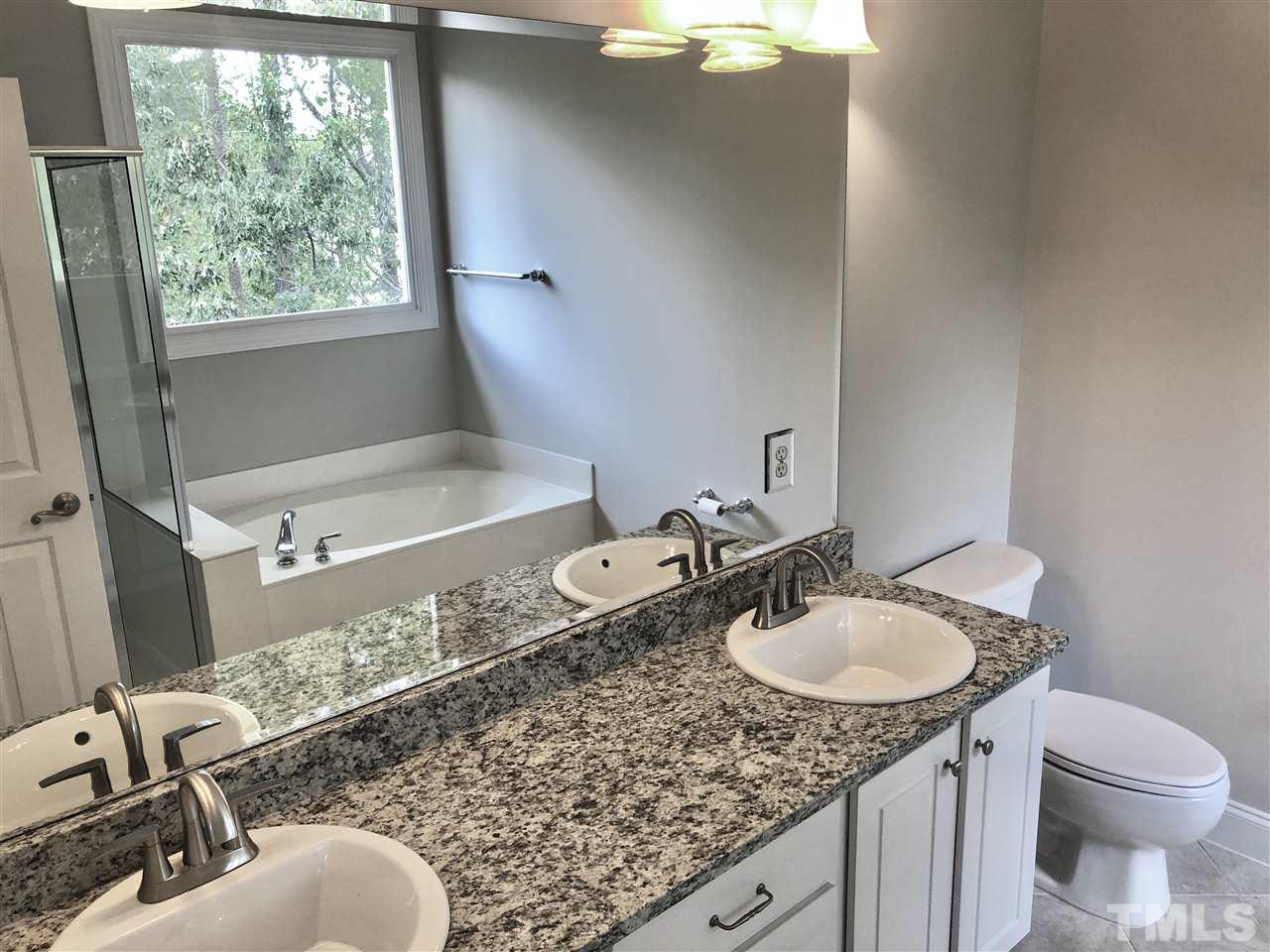 6107 Shandwick Court Raleigh, NC 27609 - Photo 11 of 21 New granite counters, sinks, faucets, lights and mirror.
