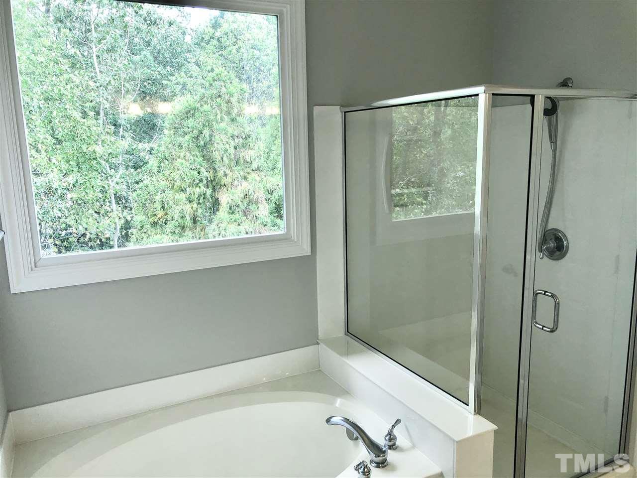 6107 Shandwick Court Raleigh, NC 27609 - Photo 12 of 21 The master bath has a garden tub, separate shower and new showerhead.