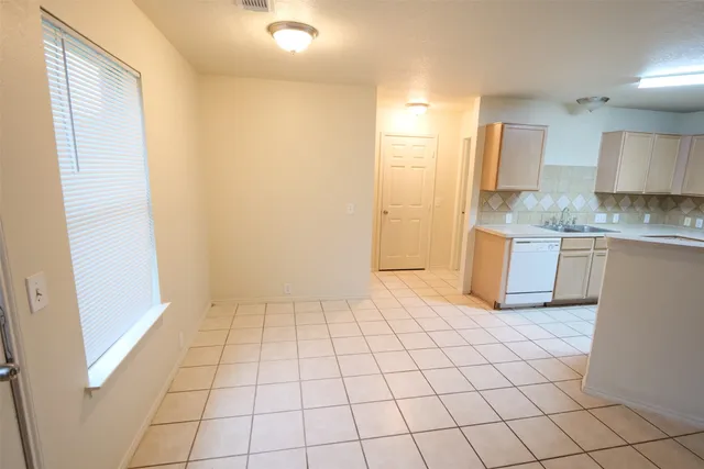 a view of kitchen with granite countertop cabinets and sink
