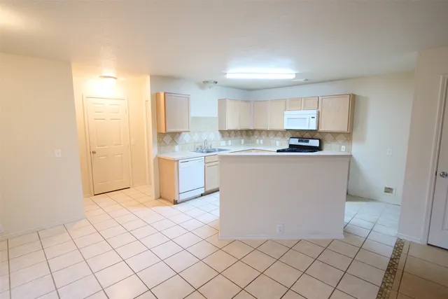 a kitchen with stainless steel appliances a refrigerator sink and cabinets