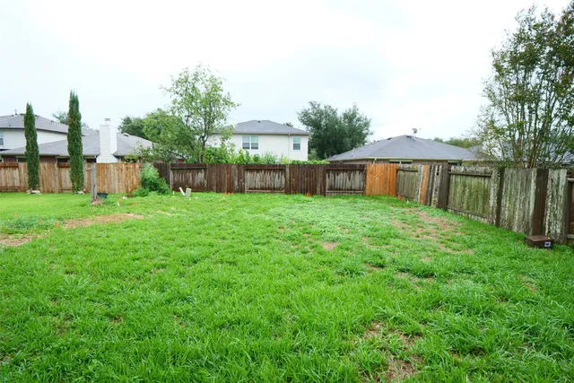 a view of a house with a yard and sitting area