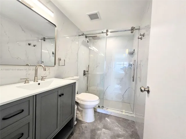a bathroom with a sink toilet and shower