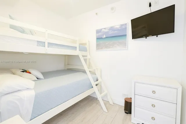 a bedroom with a bed and flat screen tv