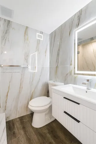 a bathroom with a sink toilet and shower