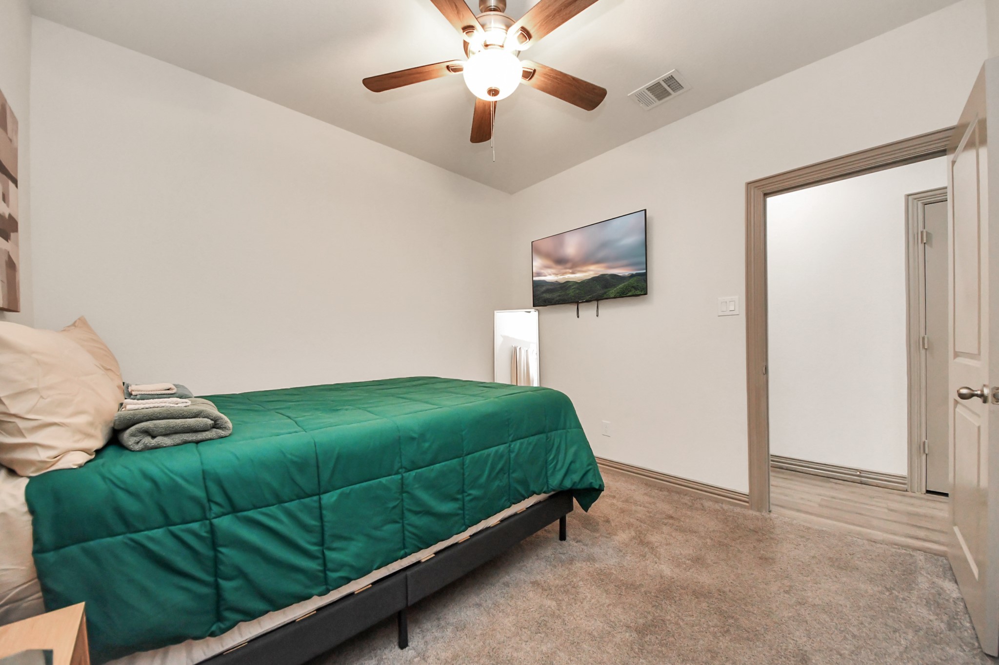 5334 Pershing Street Houston, TX 77033 - Photo 16 of 43 a bedroom with a bed and a ceiling fan