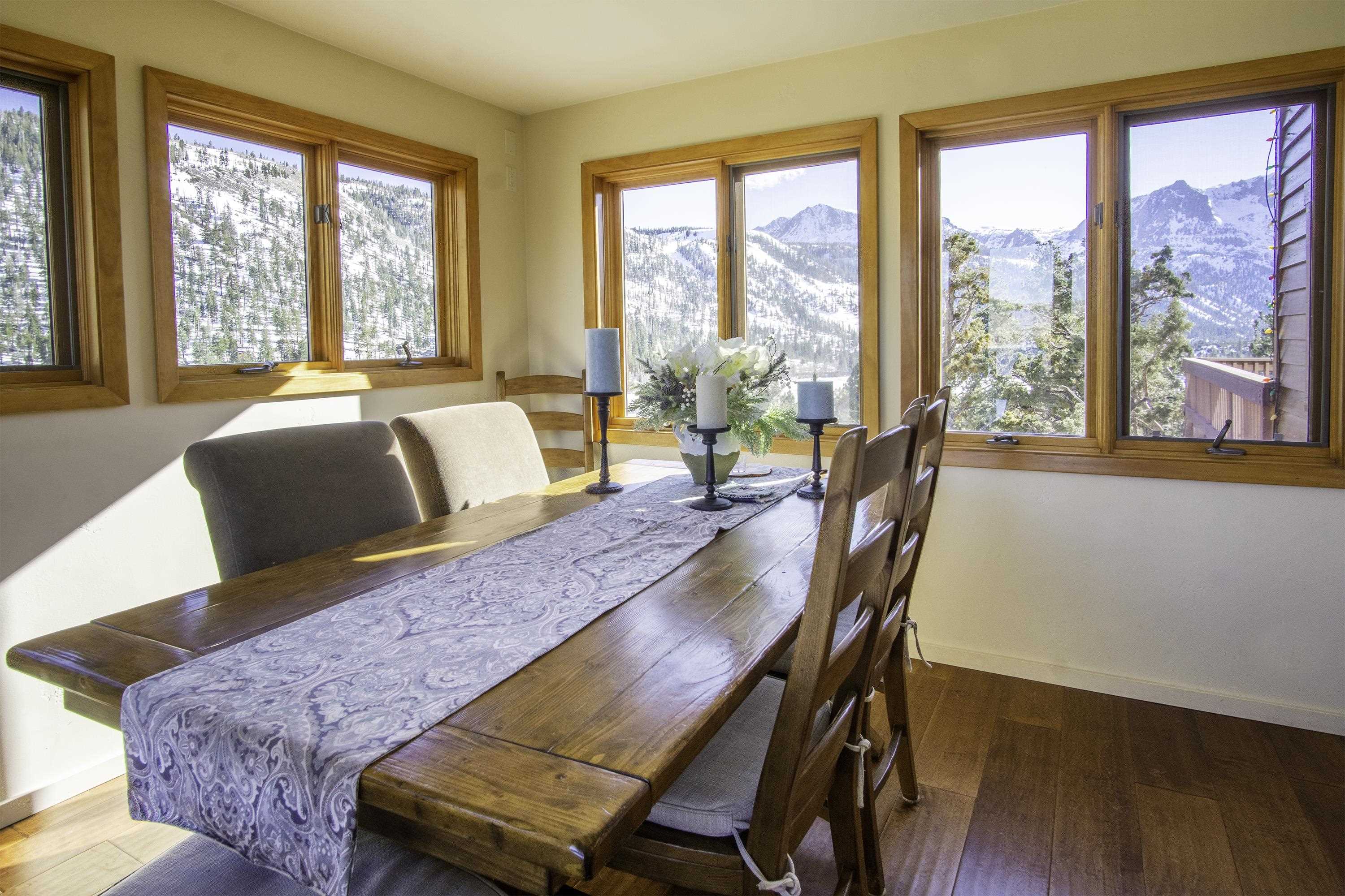 214 Skyline Road June Lake, CA 93529 - Photo 12 of 39 a view of a dining room with furniture and a large window