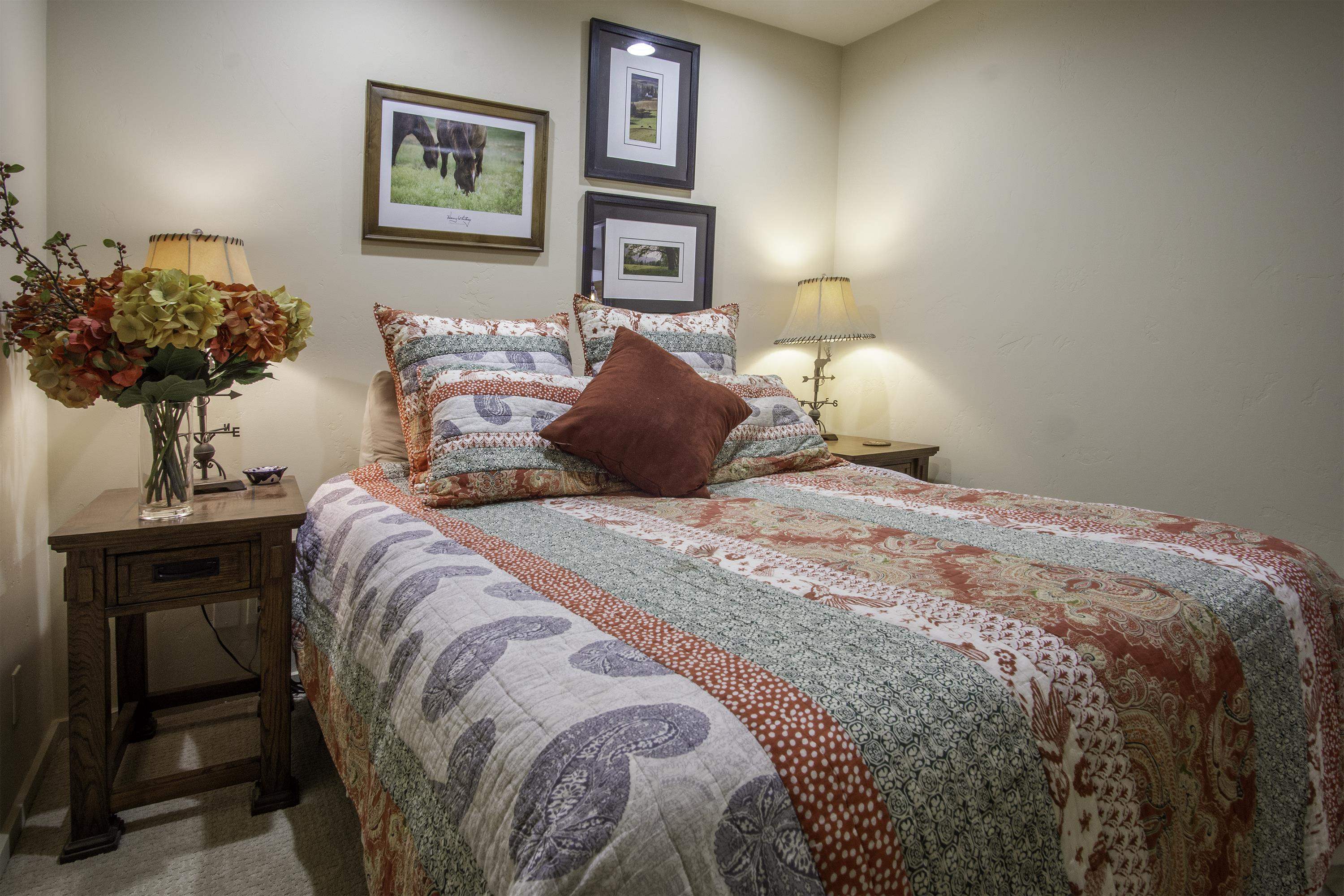 214 Skyline Road June Lake, CA 93529 - Photo 15 of 39 a bedroom with a bed and a chandelier