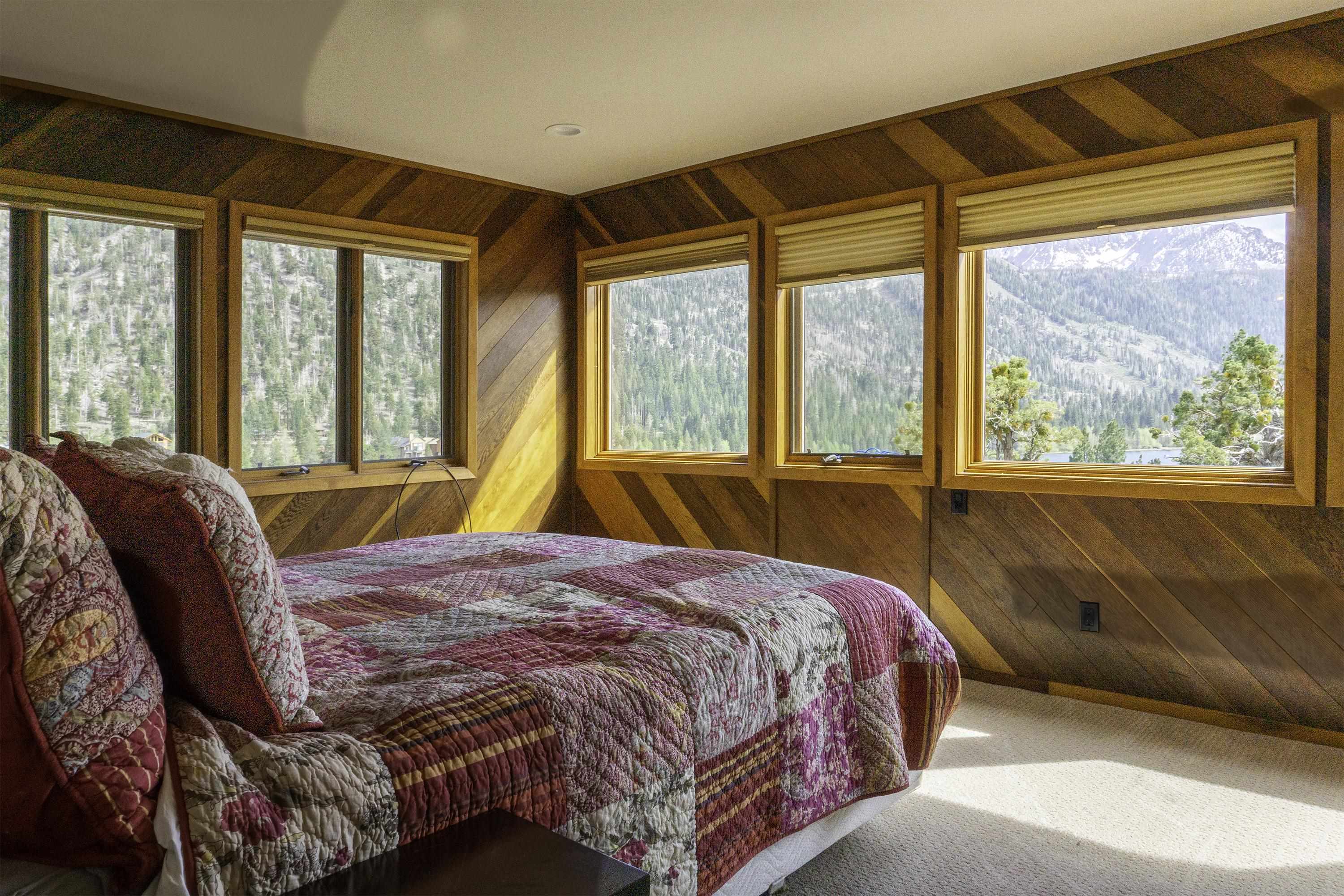 214 Skyline Road June Lake, CA 93529 - Photo 23 of 39 a bedroom with a large bed and a large window