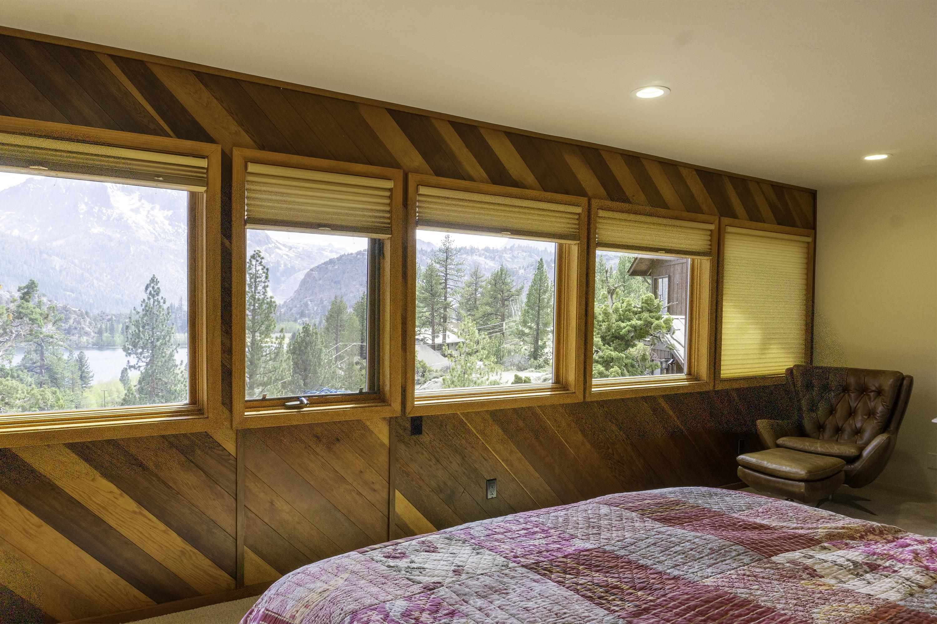 214 Skyline Road June Lake, CA 93529 - Photo 24 of 39 a bedroom with a large bed and a large window