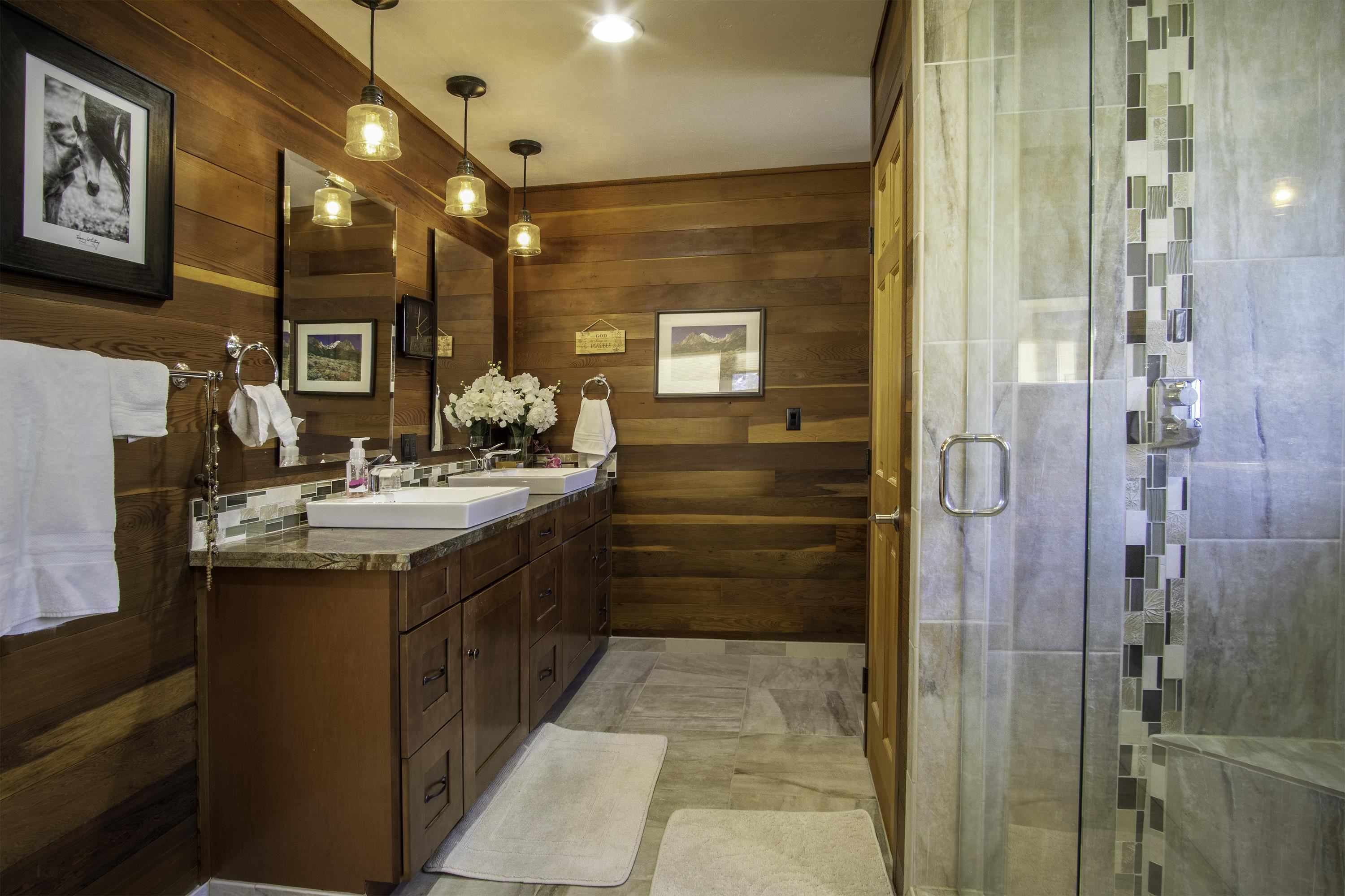 214 Skyline Road June Lake, CA 93529 - Photo 27 of 39 a bathroom with a double vanity sink a mirror and a shower