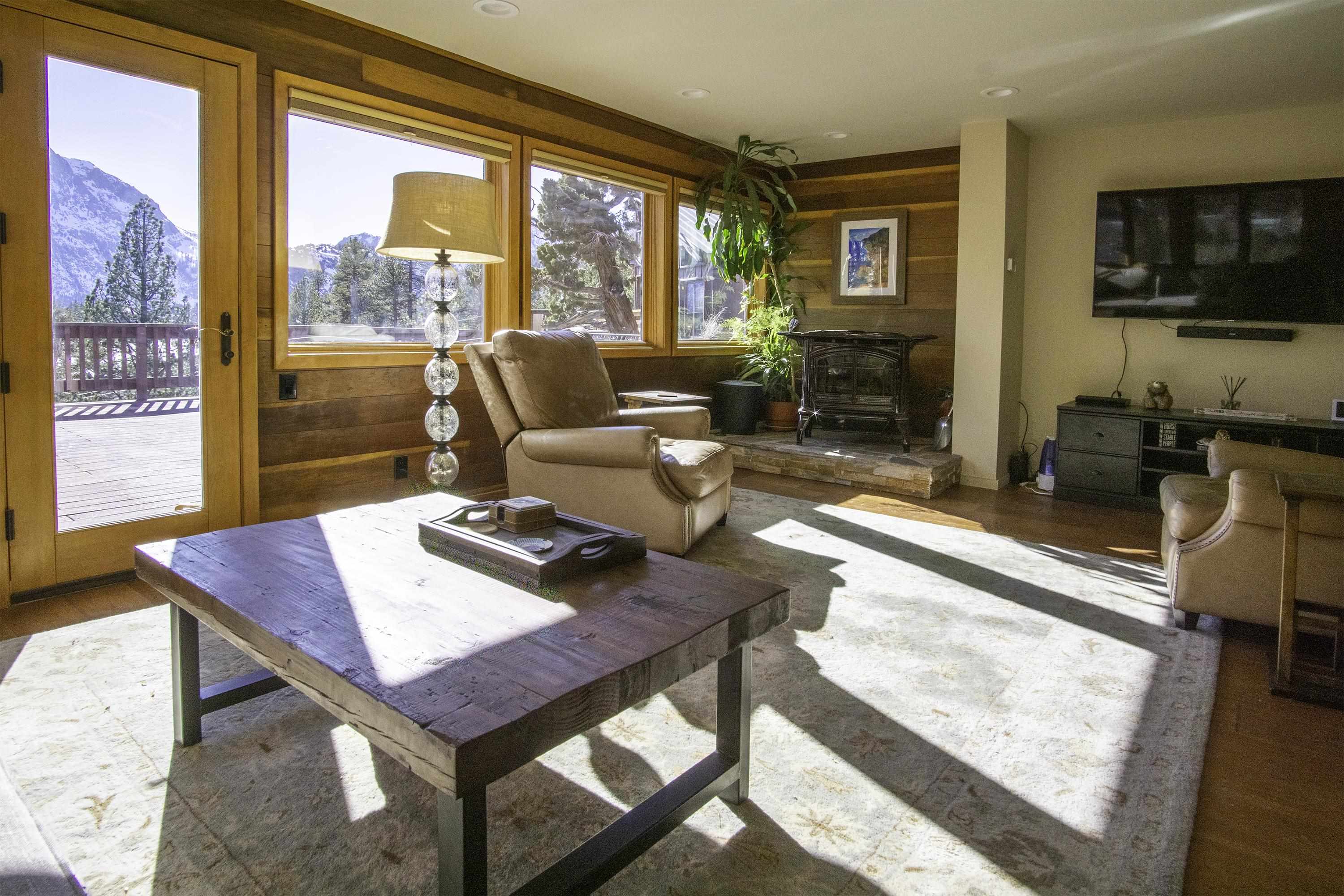 214 Skyline Road June Lake, CA 93529 - Photo 5 of 39 a living room with furniture a flat screen tv and a large window