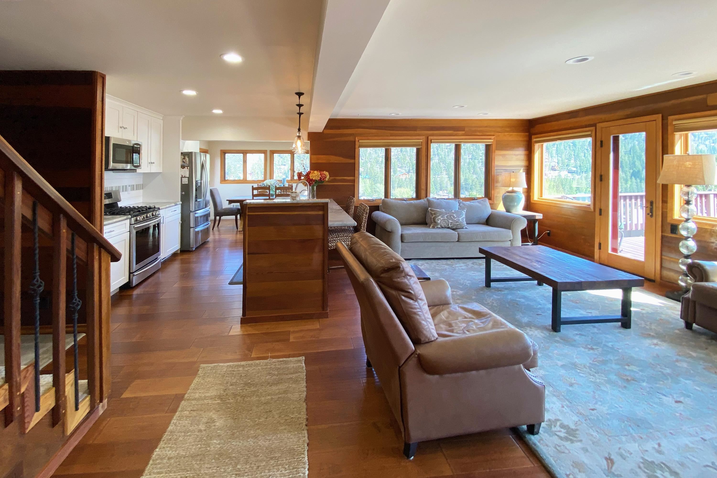 214 Skyline Road June Lake, CA 93529 - Photo 7 of 39 a living room with furniture a large window and wooden floor